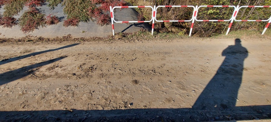 Ciężki sprzęt budowlany na lotnisku. Zniszczona ścieżka spacerowa - foto